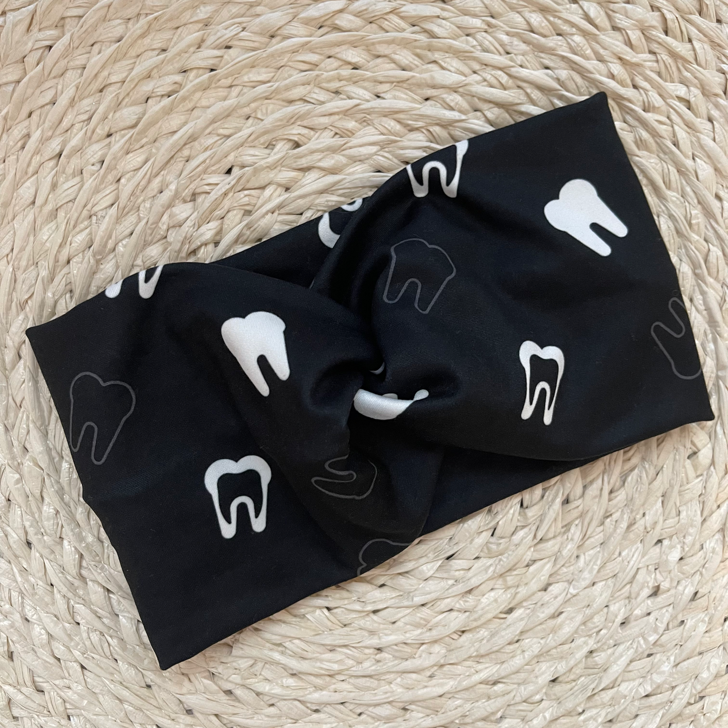 Wide, black, twisted headband with white teeth print.