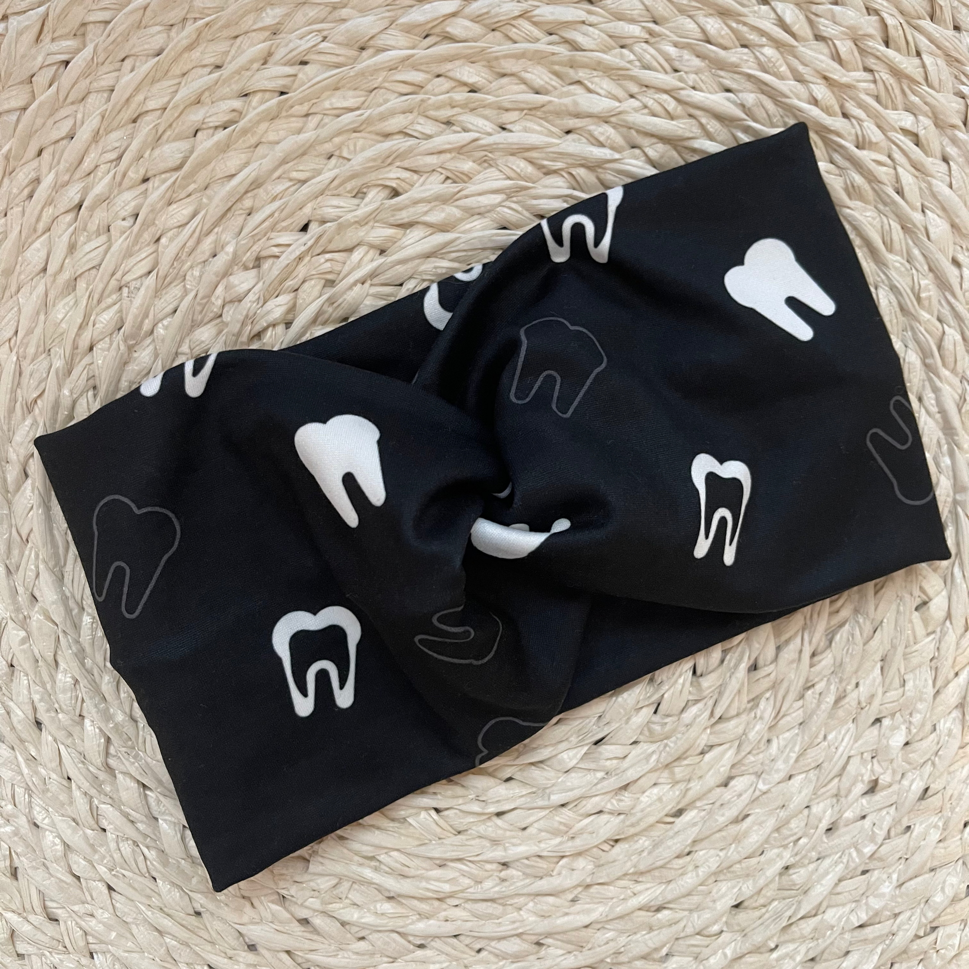 Wide, black, twisted headband with white teeth print.