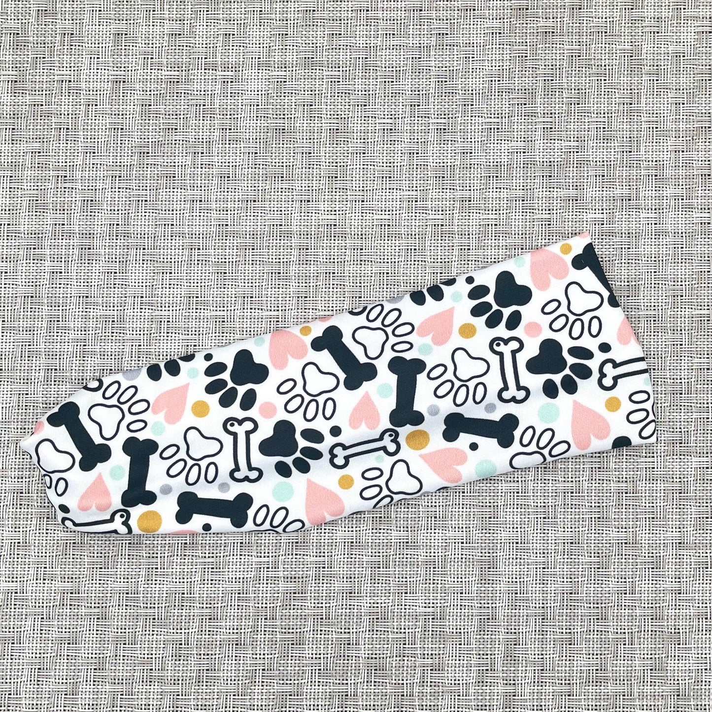 White headband with dog paws, bones, and hearts print.