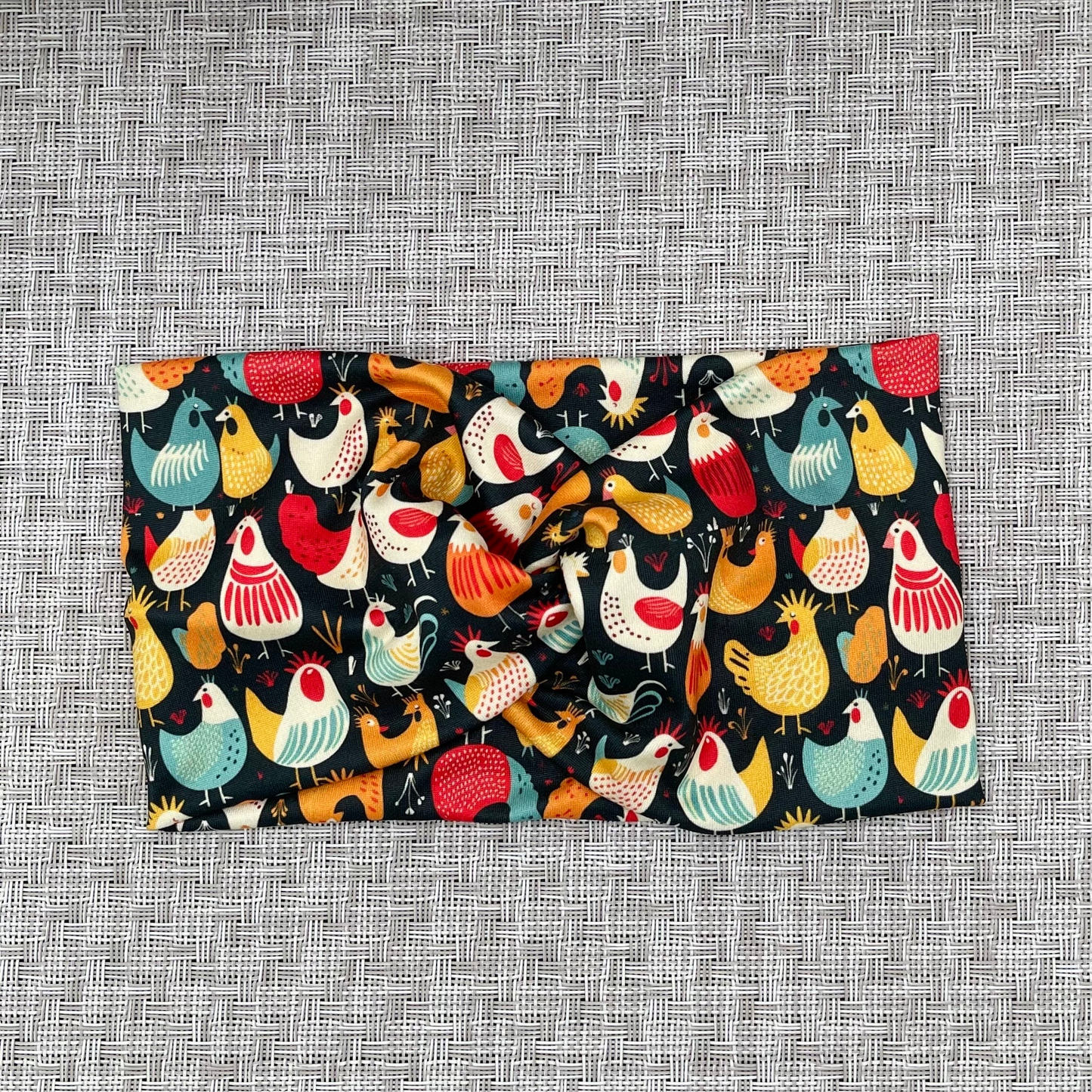 Wide, twisted headband in navy with chicken print.