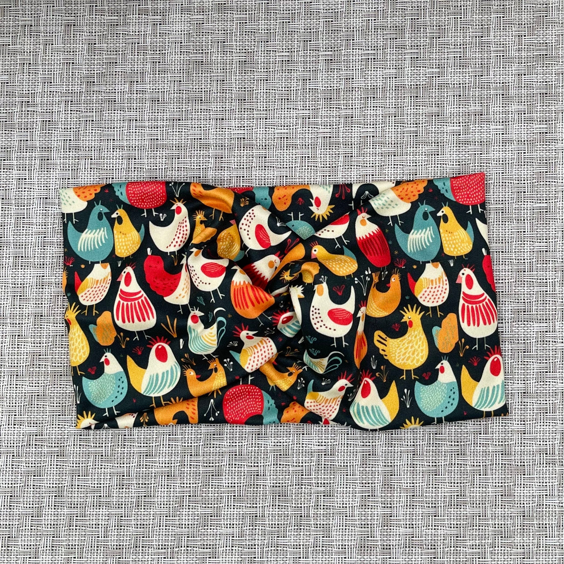 Wide, twisted headband in navy with chicken print.