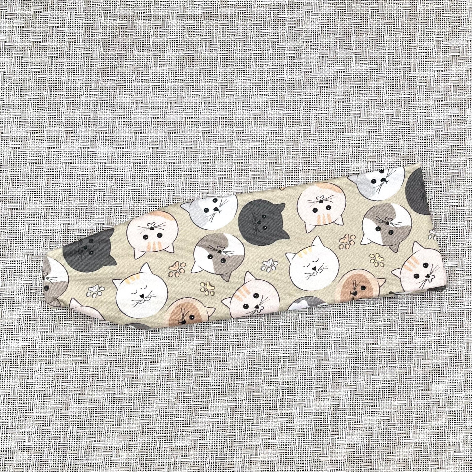 Headband with cat pattern on a textured gray background