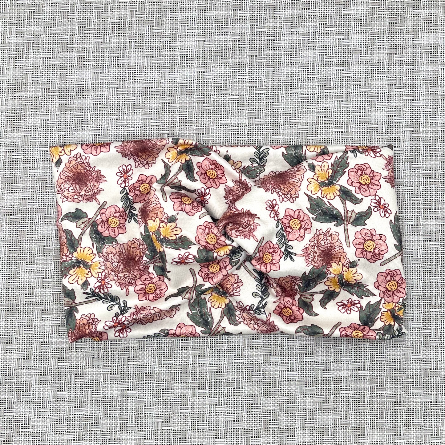 Wide, white headband with pink and yellow flowers.
