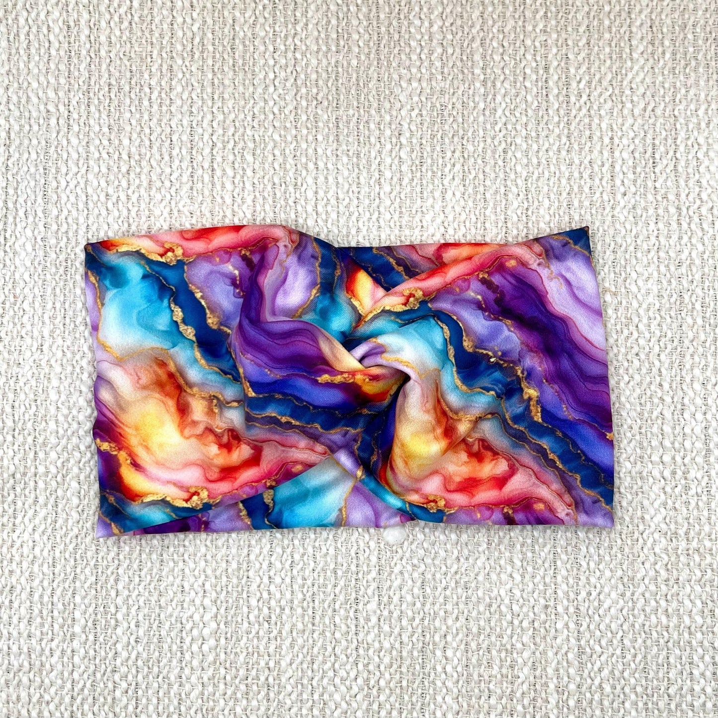 Wide, twisted headband in multi-color watercolor print.