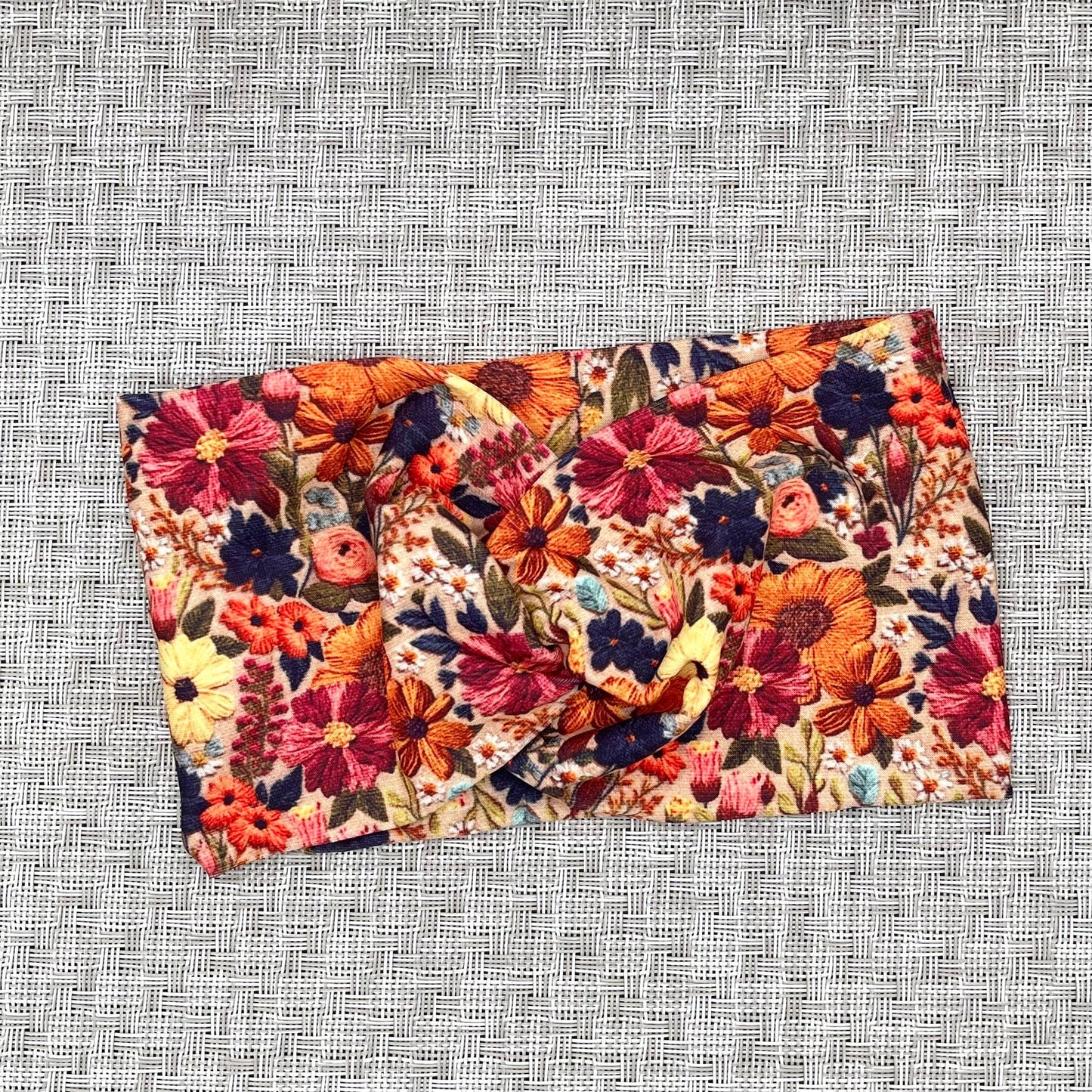 Wide, twisted headband with faux embroidered, floral print.