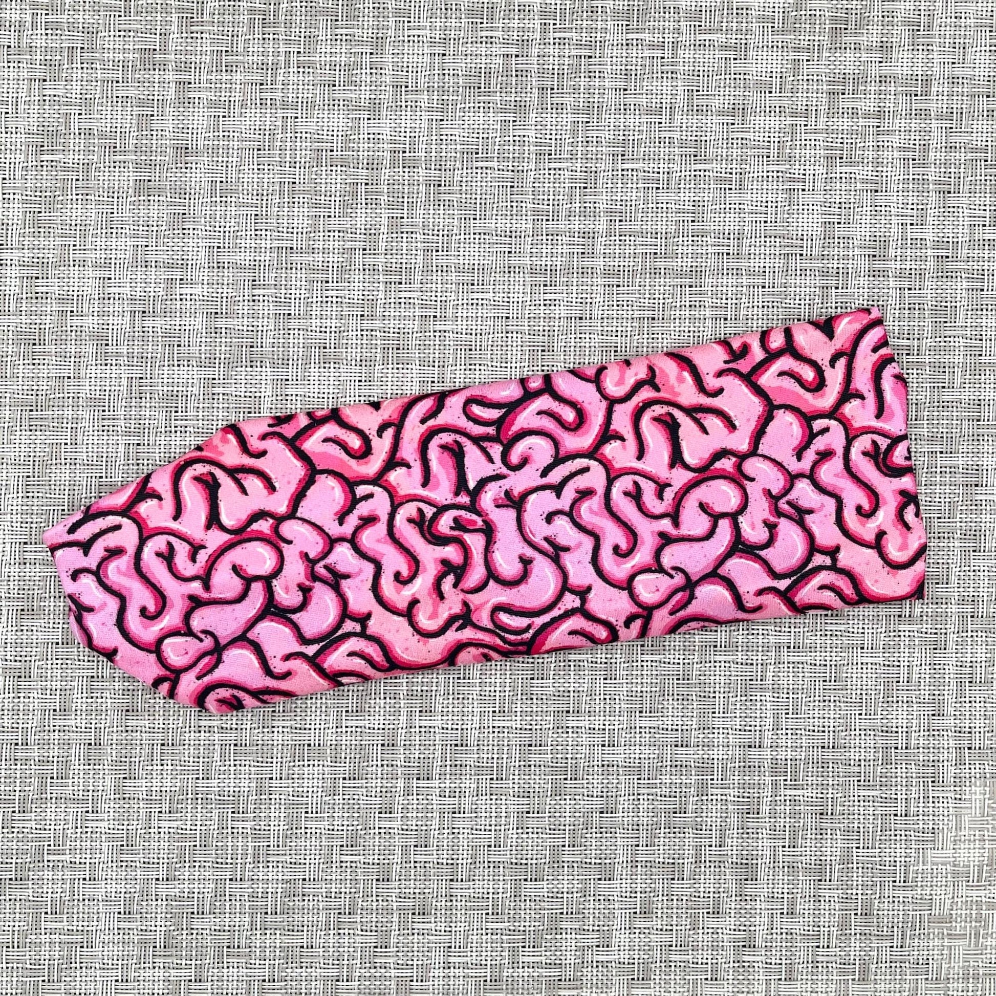 Headband with pink/black brain print.