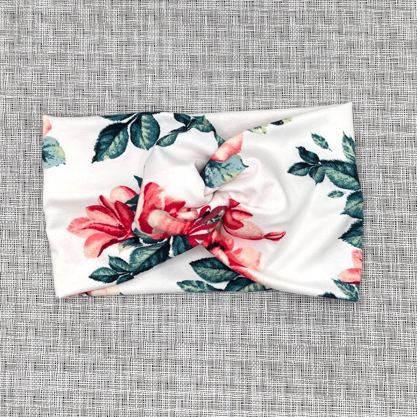 Wide, twisted headband in white with red/pink rose print.