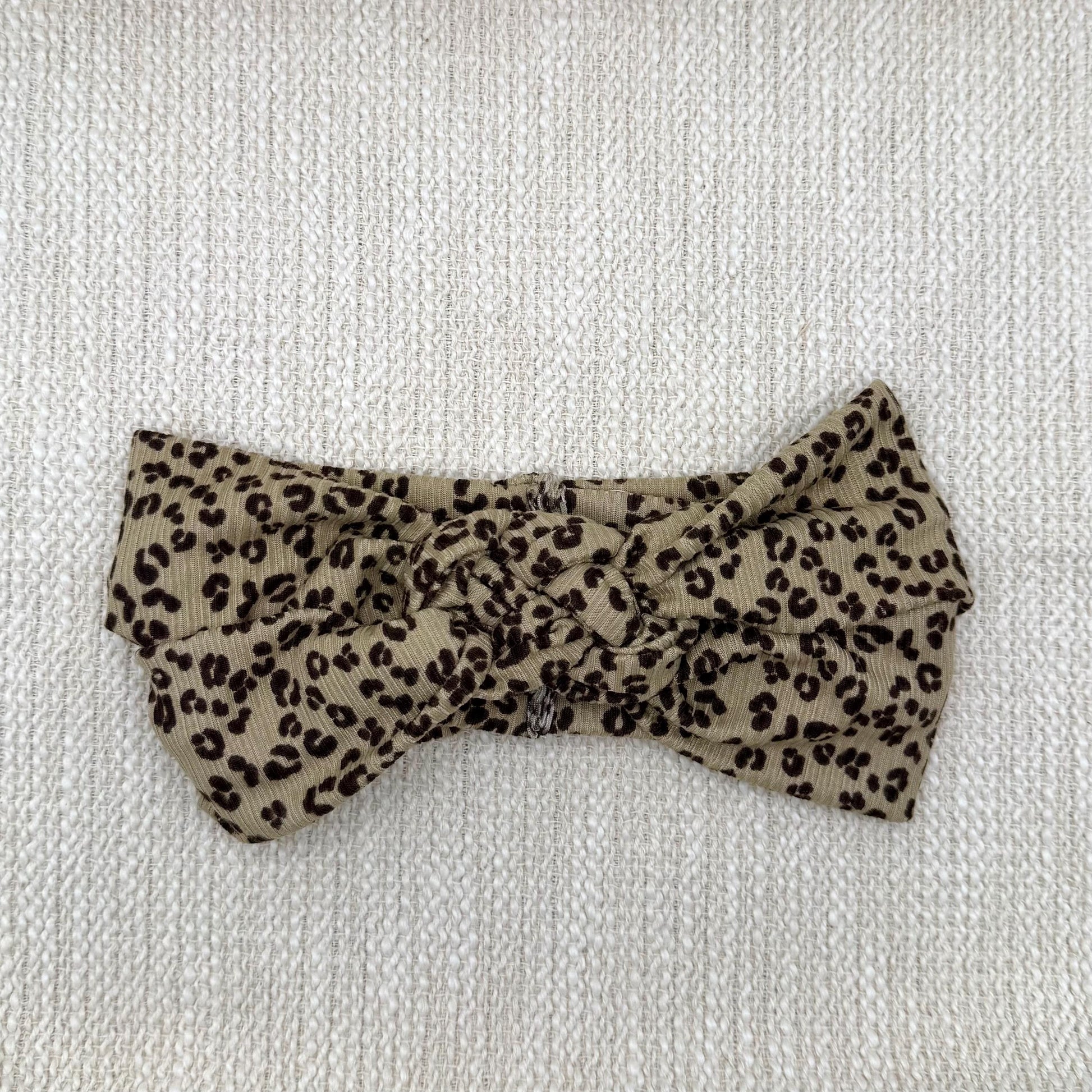 Sailor knot style headband with ribbed fabric in brown with black cheetah print.