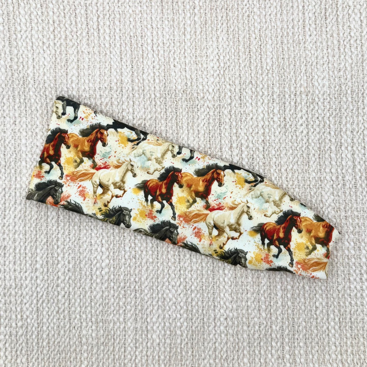 Flat, stretchy headband with horse theme print.