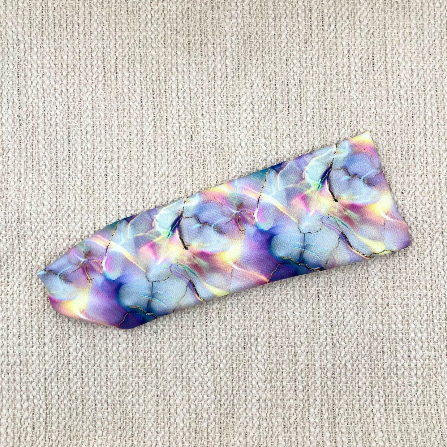 Flat, stretchy headband in multicolor watercolor print.
