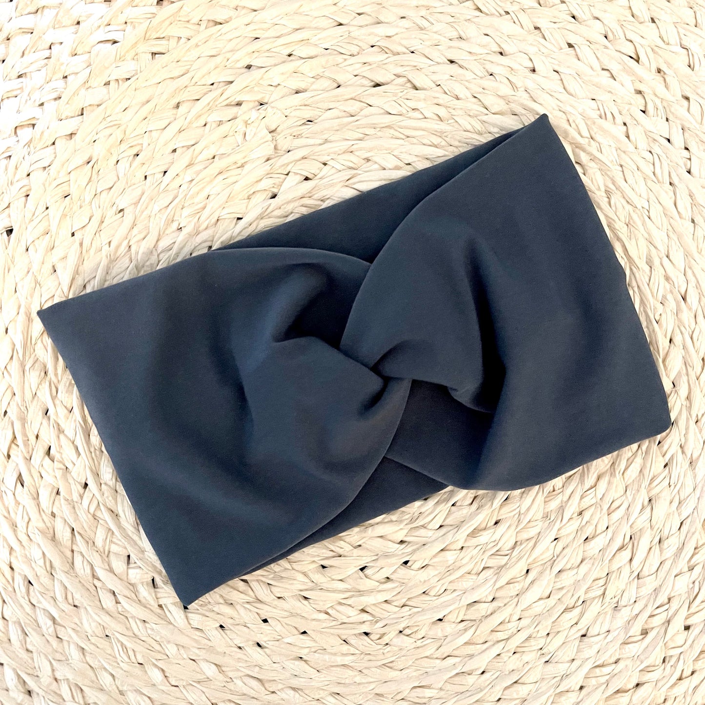Wide, twisted headband in charcoal gray.