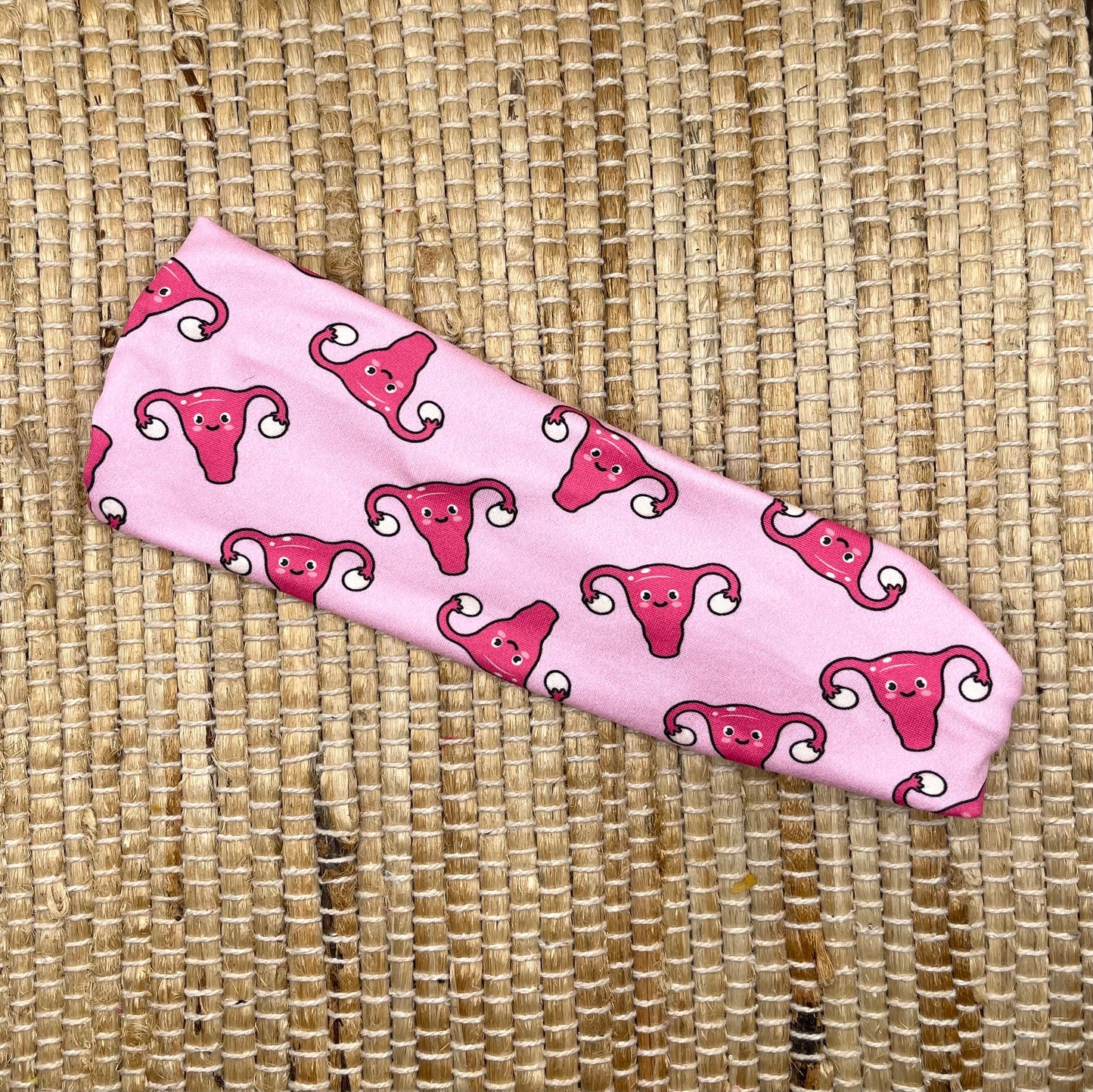 pink headband with uterus and ovaries