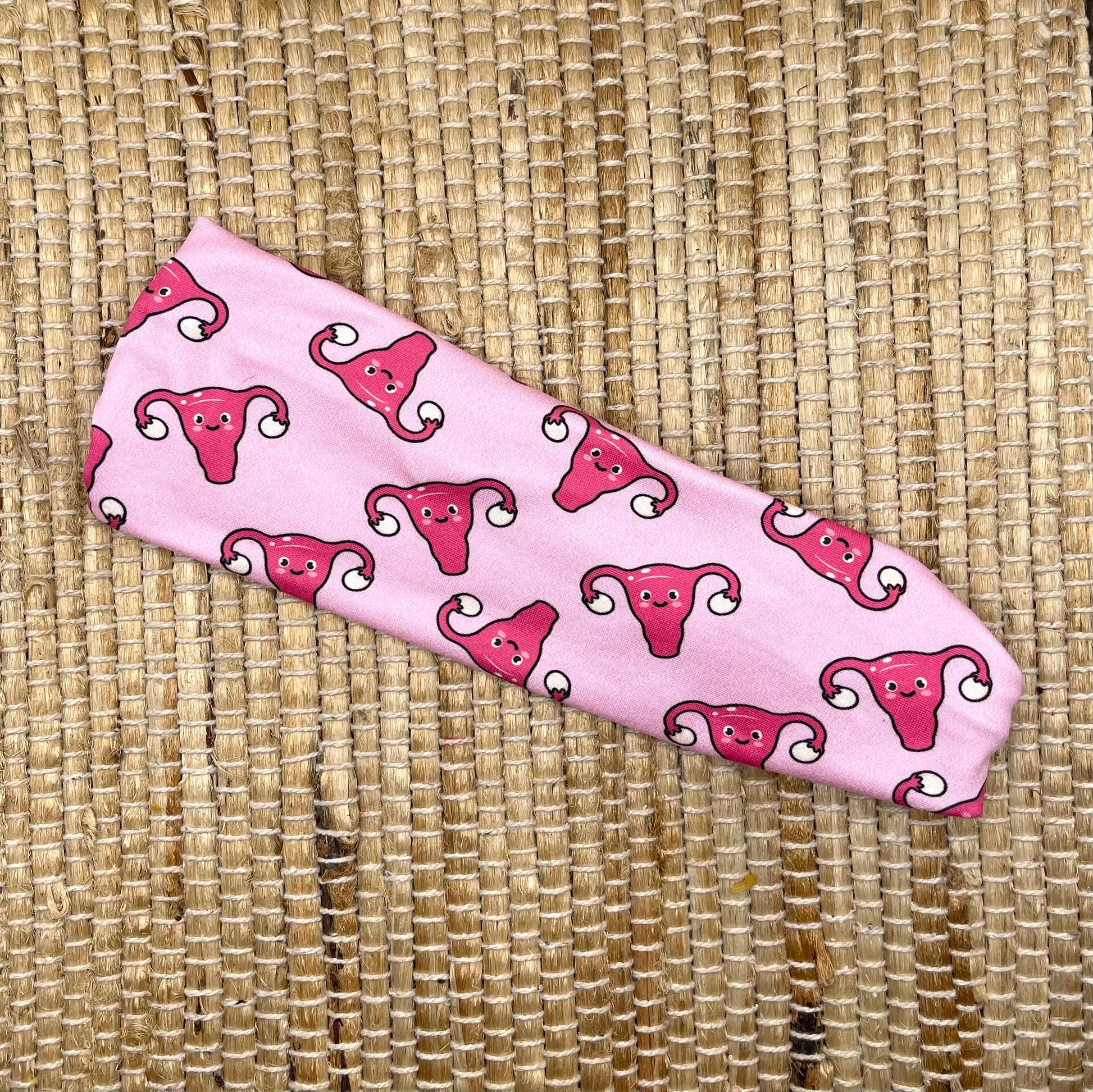 pink headband with uterus and ovaries
