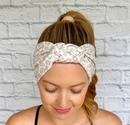 Woman with hair in ponytail wearing tan and white cheetah print headband in sailor knot style with ribbed fabric.