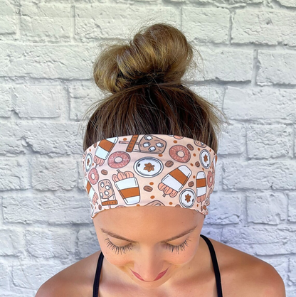 Woman with hair in bun wearing flat, stretchy headband with pumpkin spice fall theme print.
