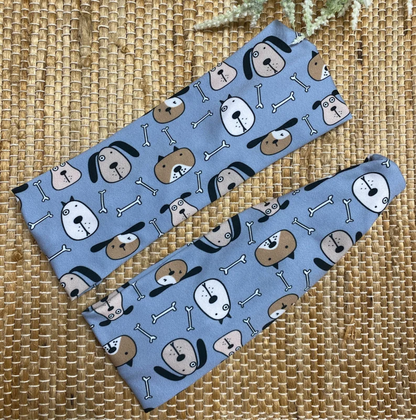 Flat, stretchy, blue headband with dog theme print.