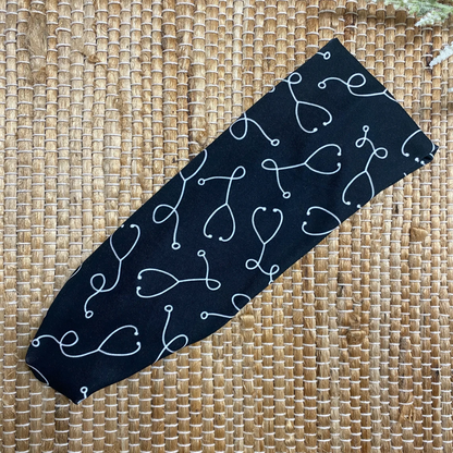 Black, stretchy headband with white stethoscope print.