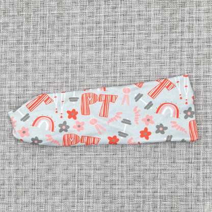 Light blue/gray headband with "PT" print in orange and PT theme print with flowers in dark gray/blue and orange.