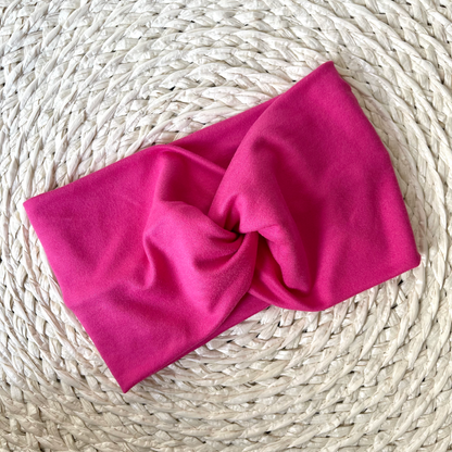 Wide, twisted headband in bubblegum, bright pink color.