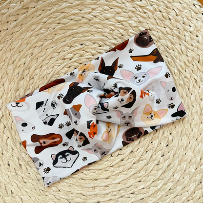 White, wide twisted headband with dog theme print.