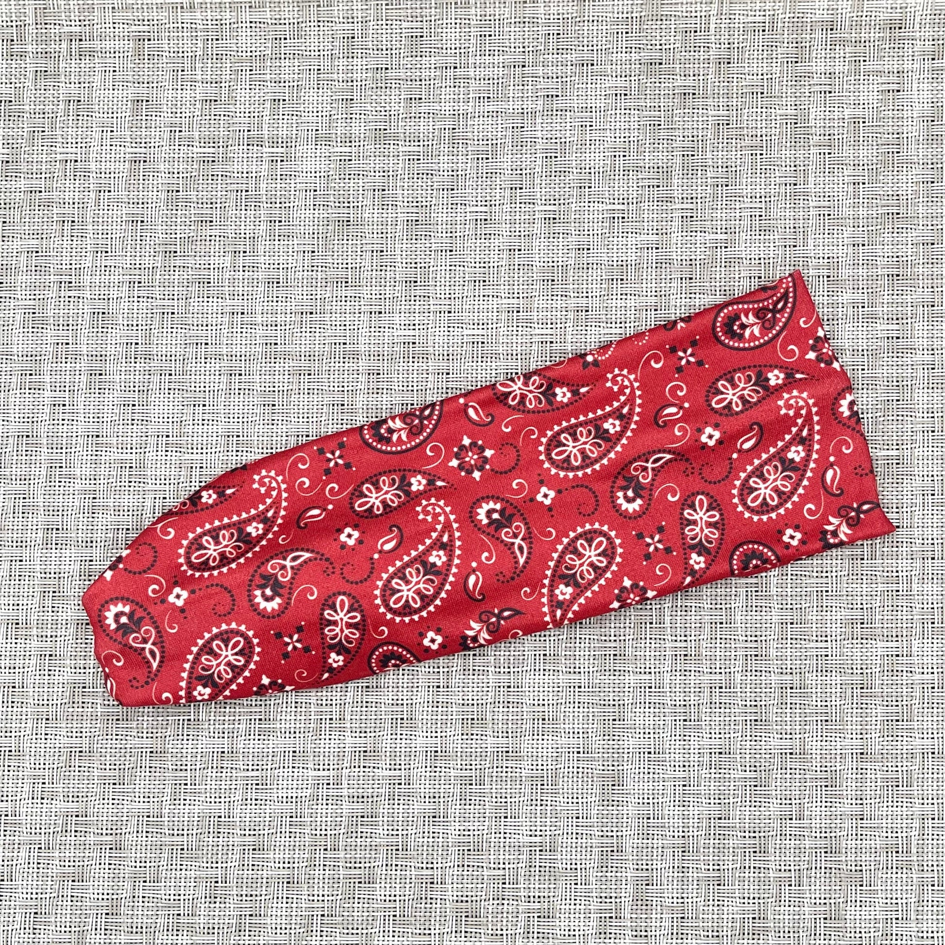 Flat, stretchy red bandana print headband.