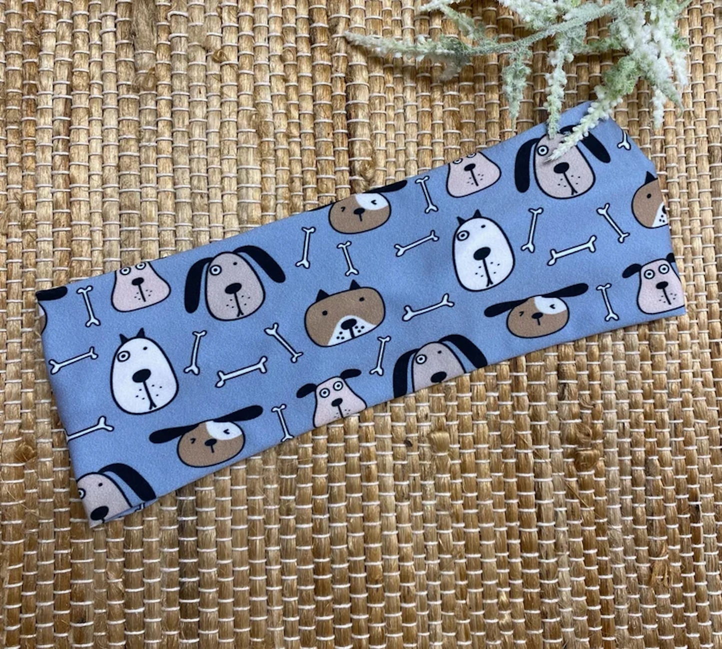 Flat, stretchy, blue headband with dog theme print.