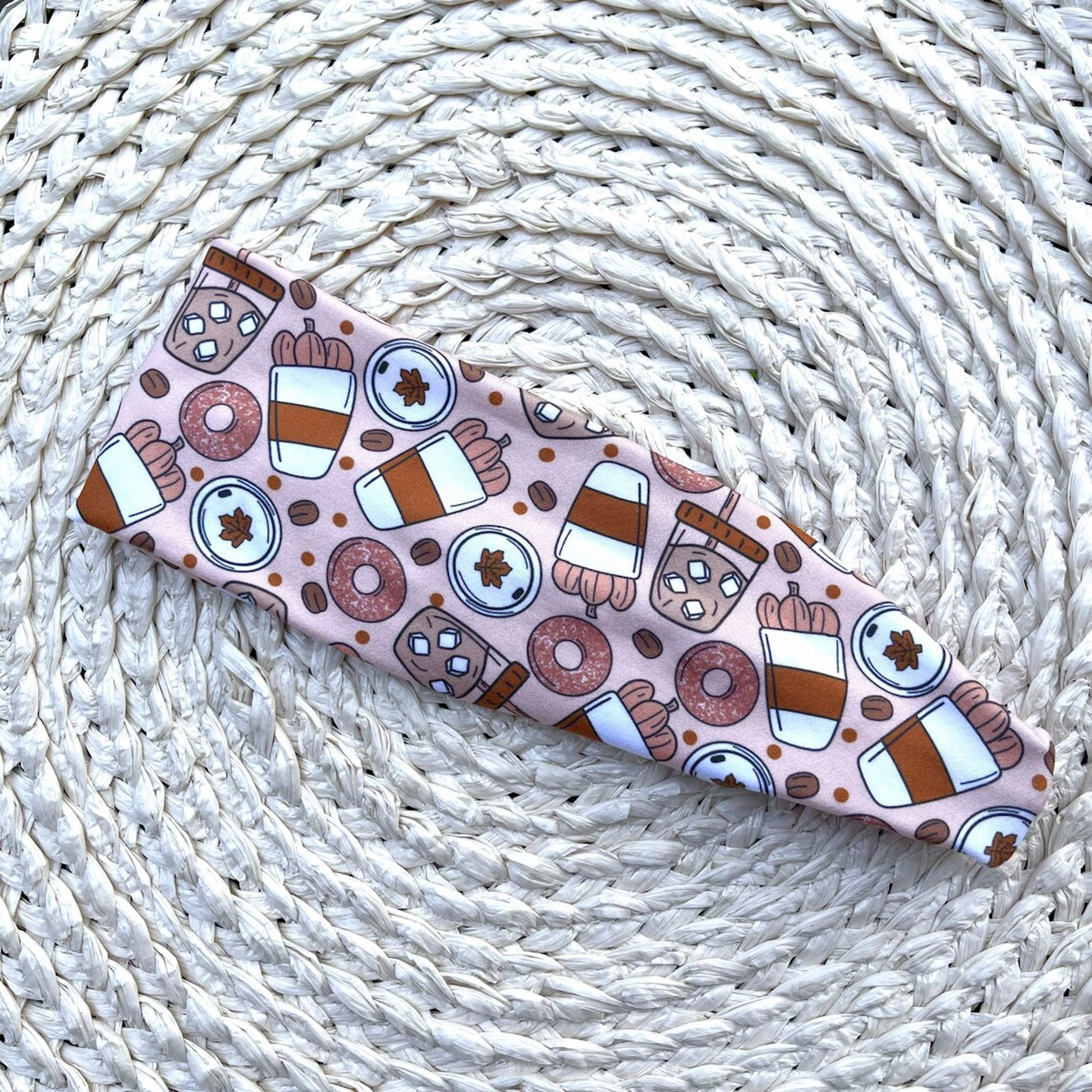 Flat, stretchy headband with pumpkin spice fall theme print.