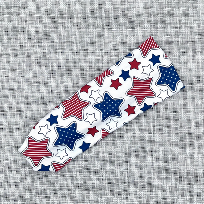 Decorative headband with red, white, and blue stars on a textured gray background