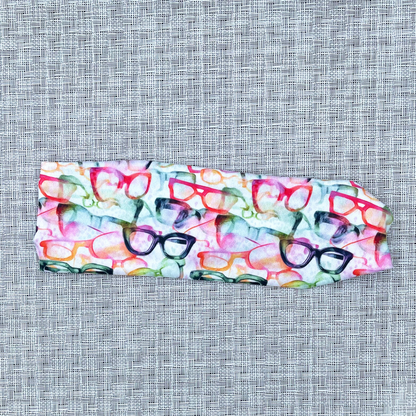 White headband with rainbow color eye glasses print.