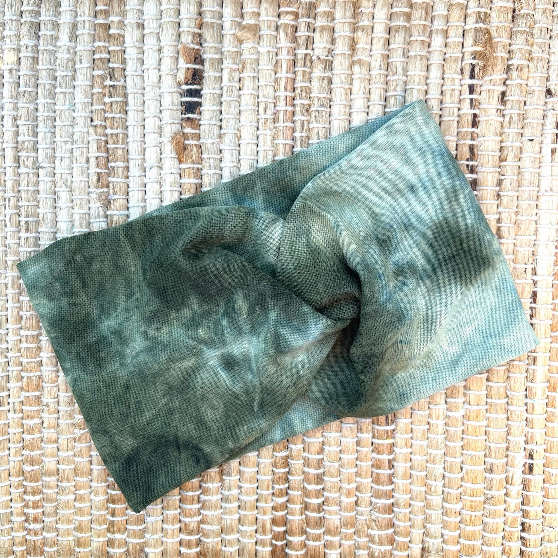 Wide, twisted headband in green tie dye print.