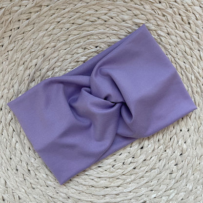 Wide, twisted headband in lavender color.