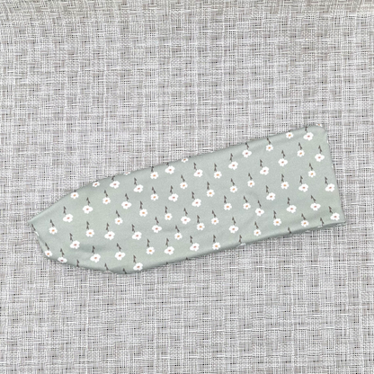 Mint color headband with small white flowers.