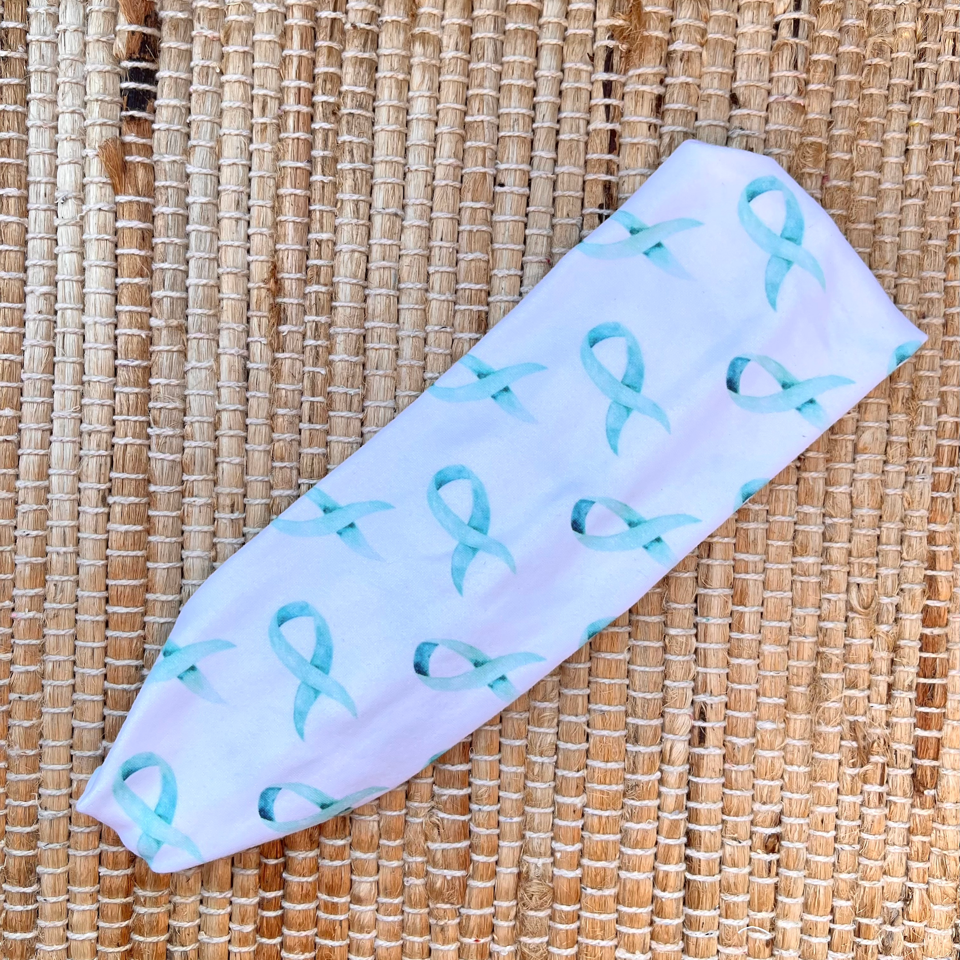 White headband with light blue ribbons print.