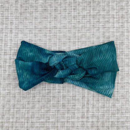 Sailot knot style headband in ribbed, teal tie dye fabric.