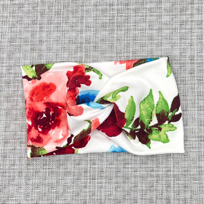 Wide, twisted headband in white color with red floral rose print.