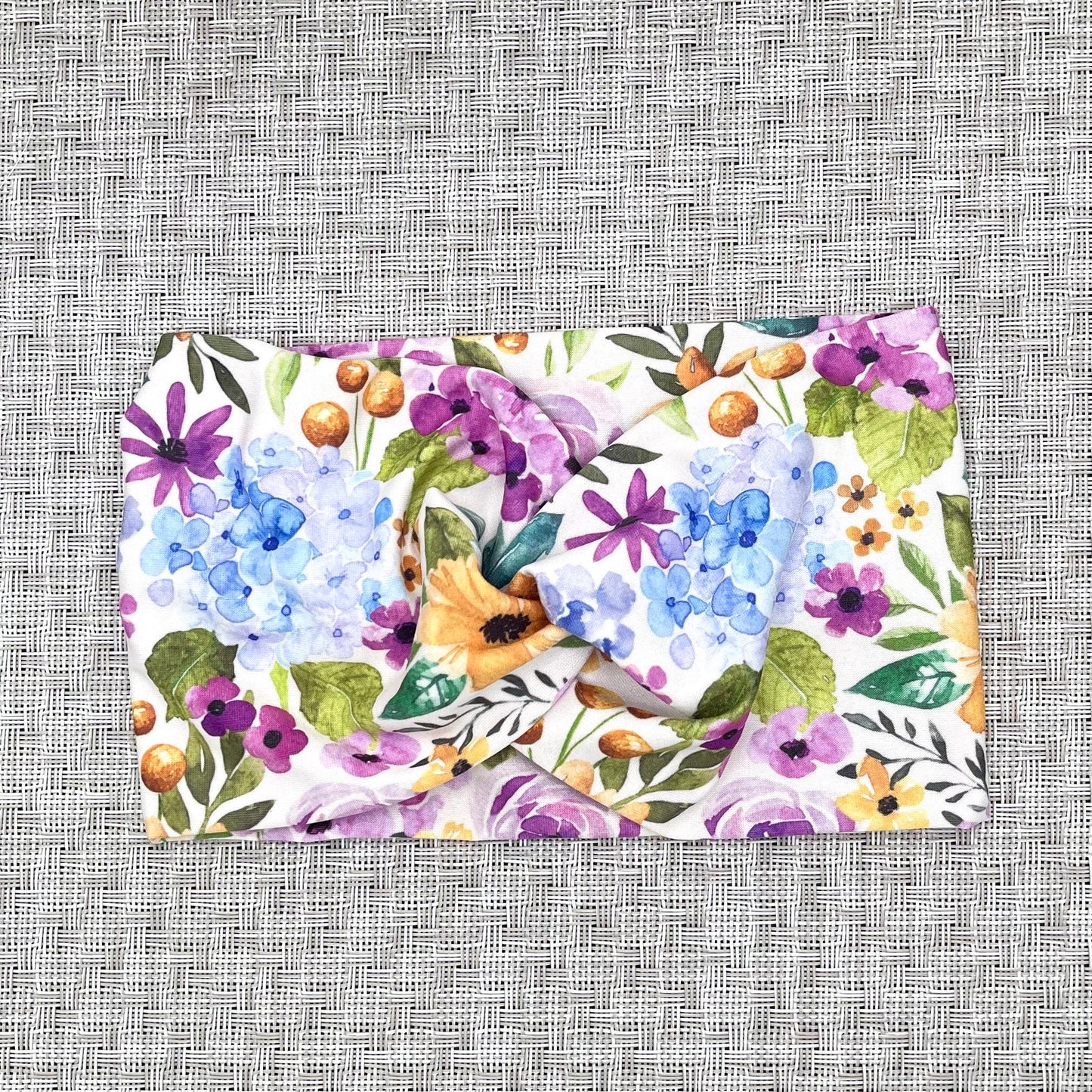 Floral patterned headband on a textured gray background