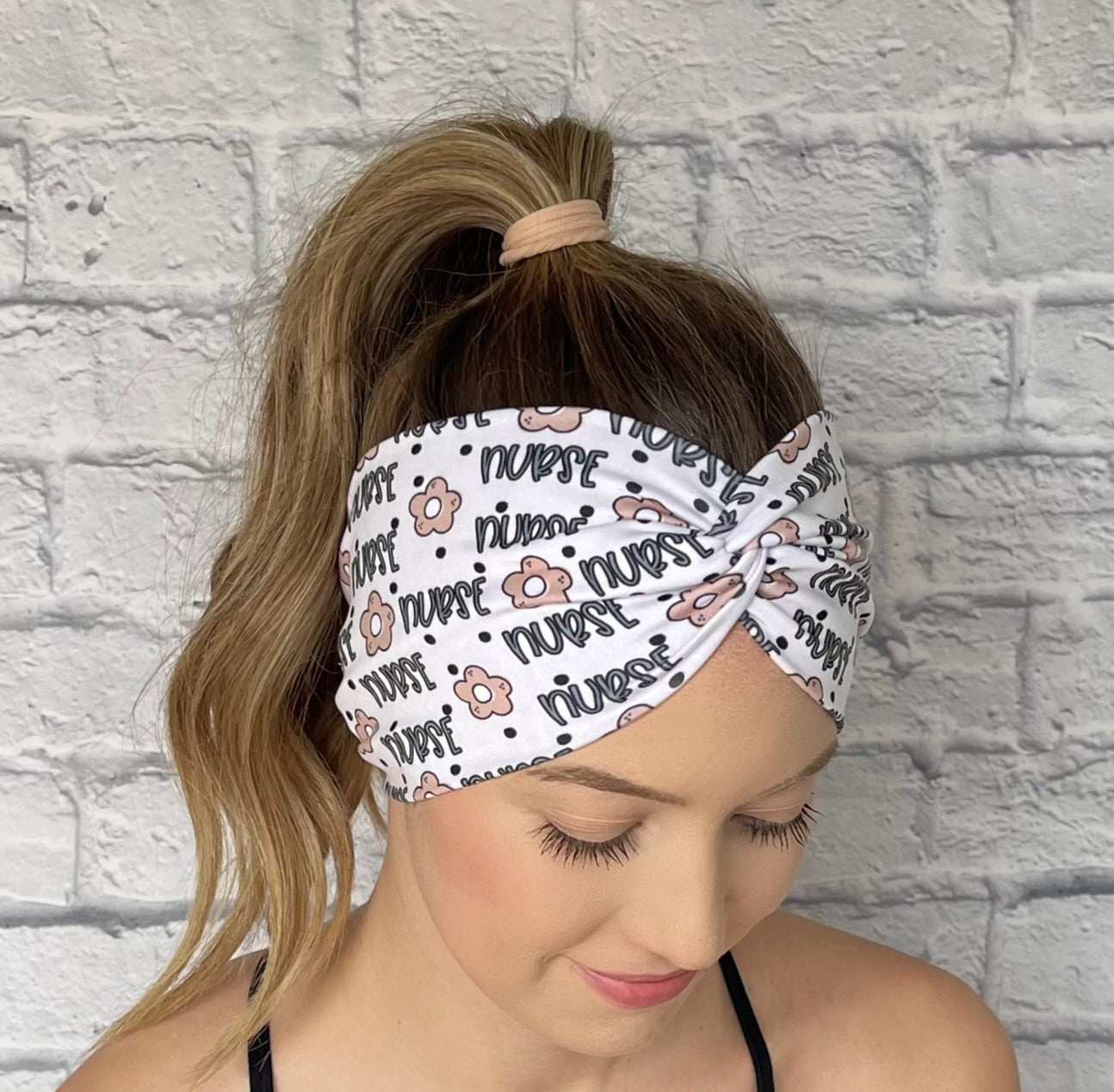 white headband with "nurse" and flower print in blue and tan