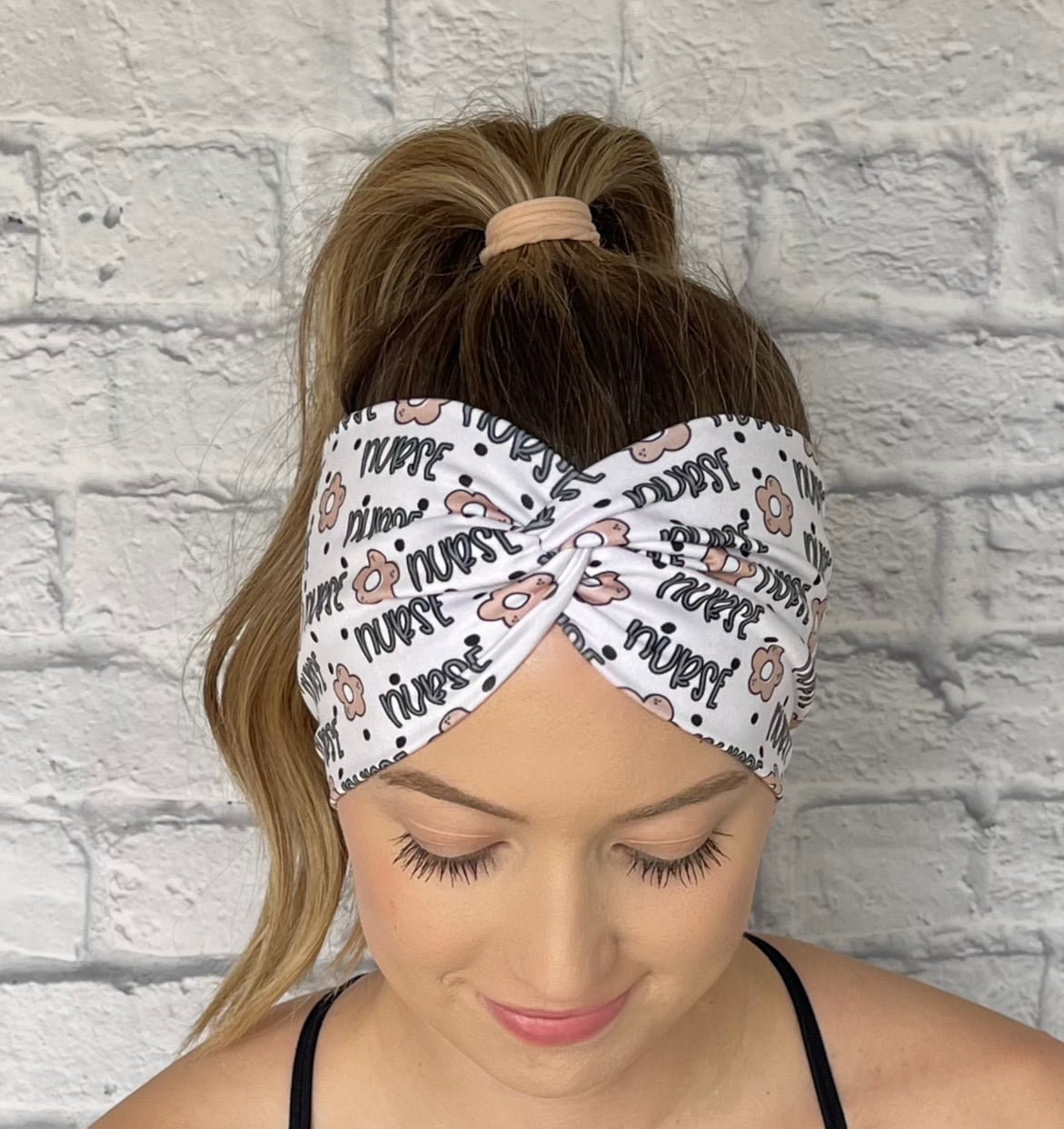 white headband with "nurse" and flower print in blue and tan