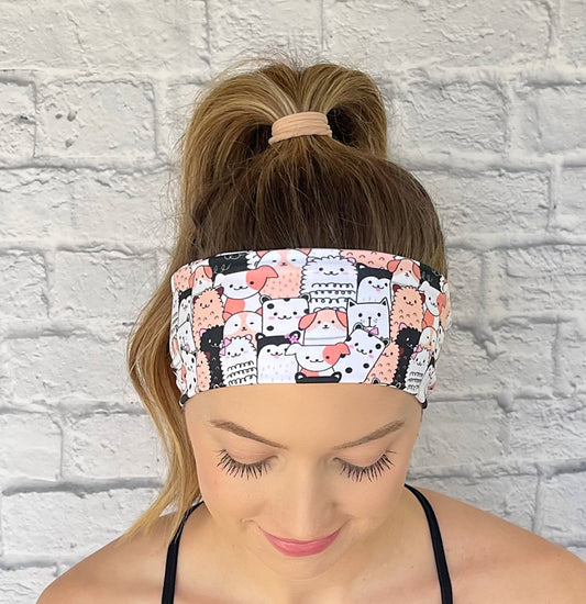 white, peach, and black patterned headband with cats and dogs