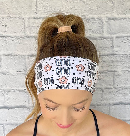 white headband with "cna", flowers, and polka dot print in blue and tan