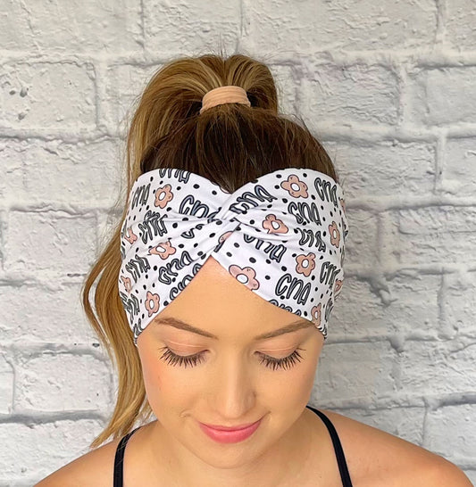 white headband with "cna", flowers, and polka dot print in blue and tan