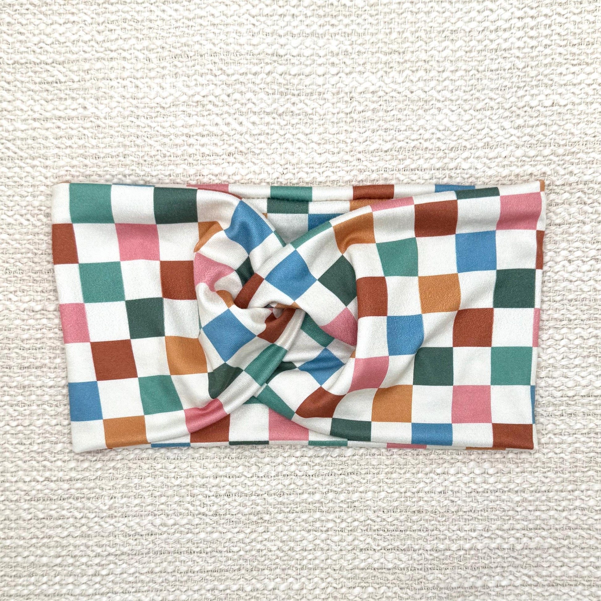 Wide, stretchy headband in multicolor checker print.