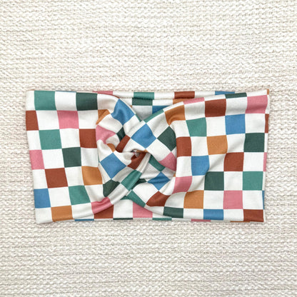 Wide, stretchy headband in multicolor checker print.
