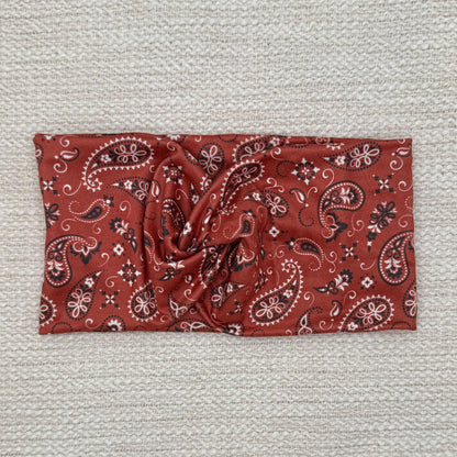 Wide, twisted, red bandana print headband.