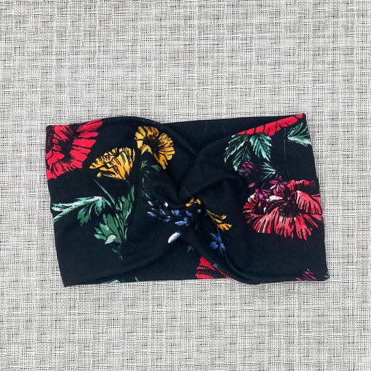 black, wide twist headband with yellow, red, blue, and purple flowers