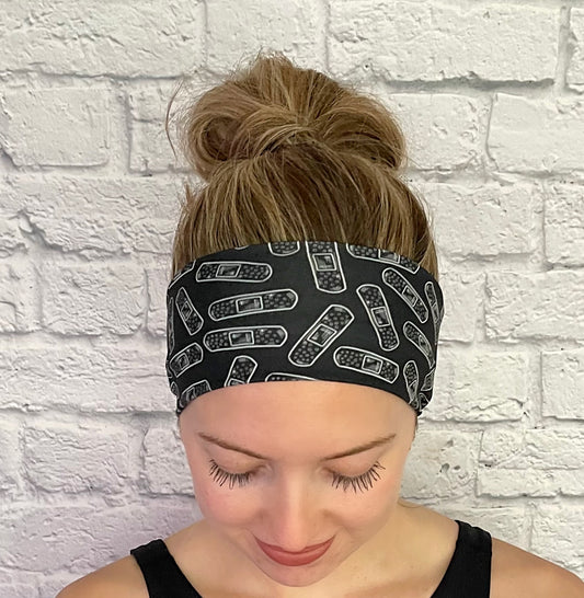 black headband with white bandages