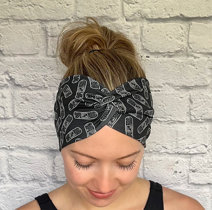 black headband with white bandage