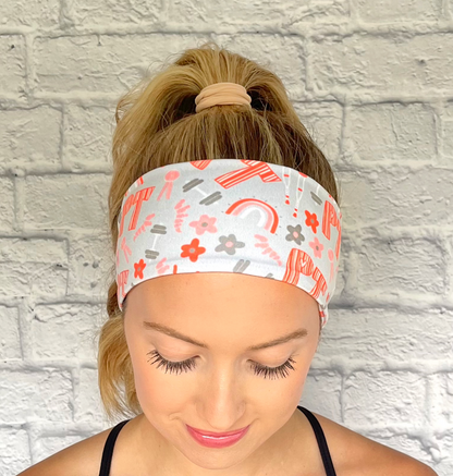 light blue/gray headband with "PT" print in orange and PT theme print with flowers in dark gray/blue and orange