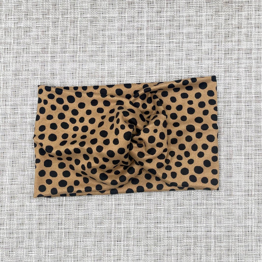 light brown, wide twisted headband with black dotted print