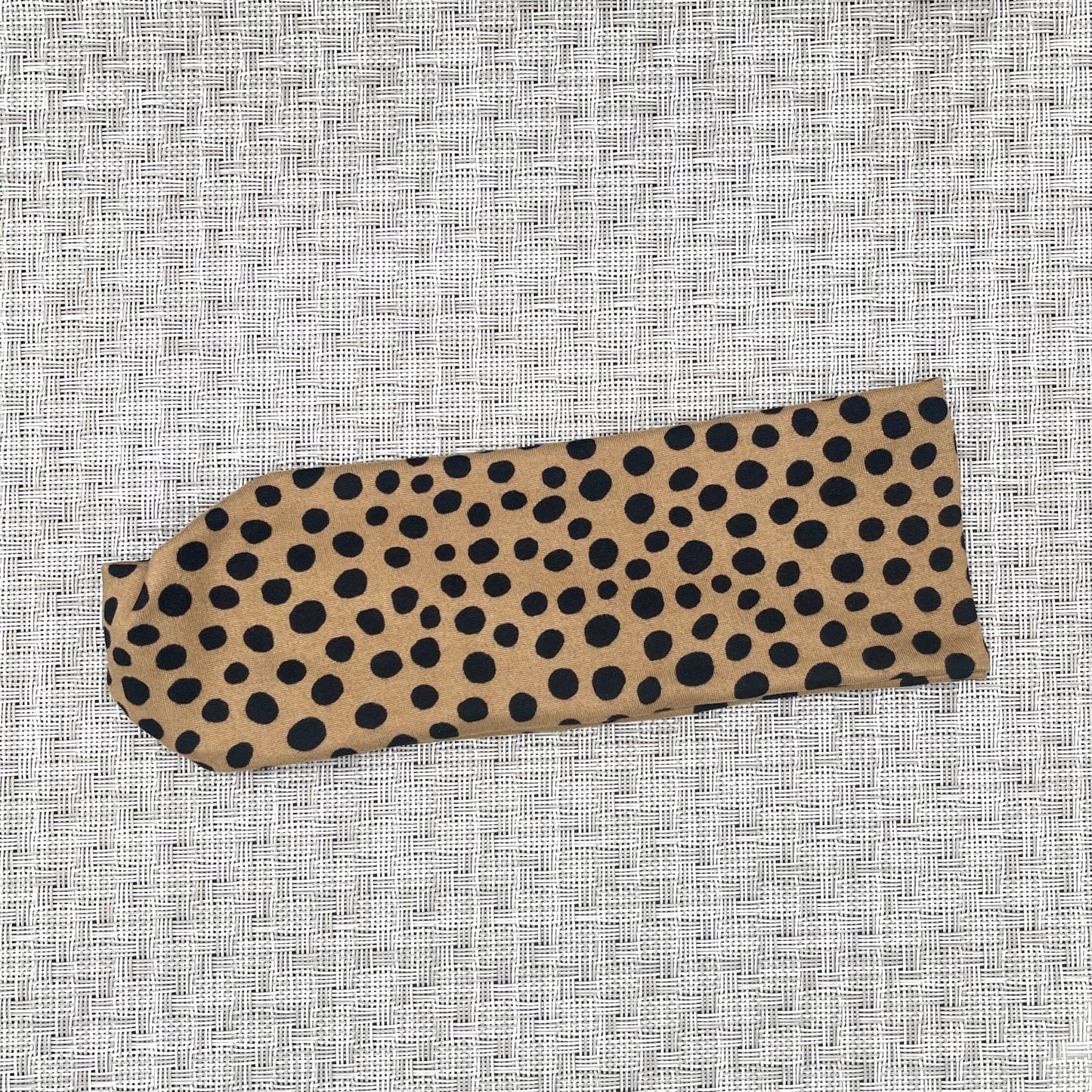 light brown headband with black spots